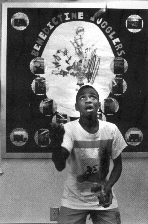 Henry works in front of the club banner.