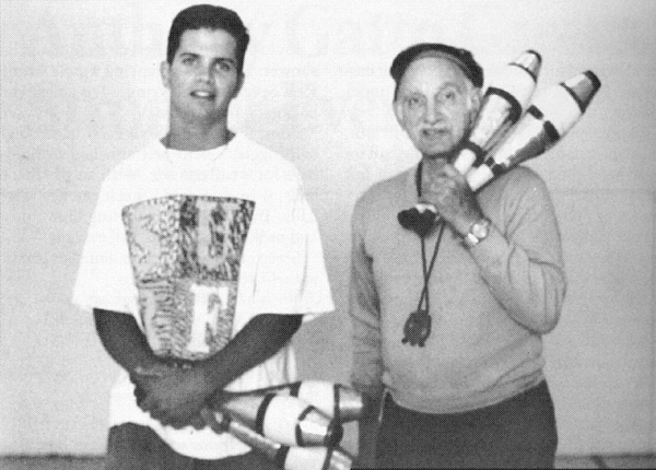 Anthony holds the clubs, Nick the stopwatch in their practice sessions.