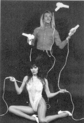 August juggles plugged in hair driers in Vegas act.