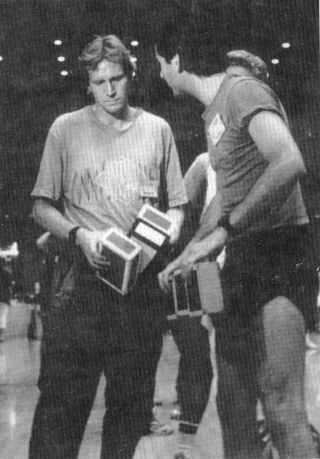 Kris Kremo looks over cigar boxes as Rob Peck makes a point.