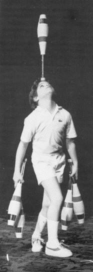 Unable to hold all five clubs at once, Anthony begins that part of his routine this way.