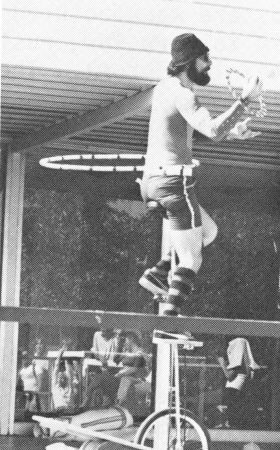 On a unicycle at Montclair High School in  Montclair, Cal., Vaksman spins a hula hoop on his waist and a ring on his wrist while juggling three balls.