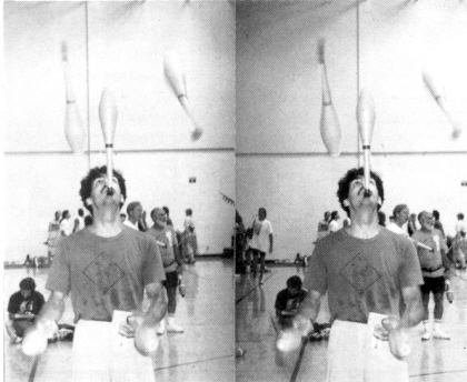 Unknown juggler with 4 clubs and one in balance.
