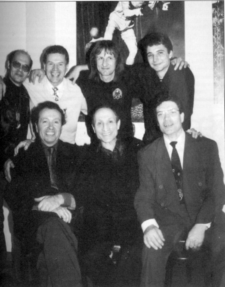 A rare confluence of juggling stars occurred recently at the Variete Tiger Palast in Frankfurt, Germany.  Bob Bramson (seated, l) was performing there when he was visited one night by Frances Brunn (seatd, c), Ernest Montego (seated, r) and (standing l-r) Karl-Heinz Ziethen, toly M of the Castors, Sergei Ignatov and Oliver Groszer.  They are posed in front of a poster of Enrico Rastelli, and gathered on the date of the 60th anniversary of Rastelli's death, December 13.