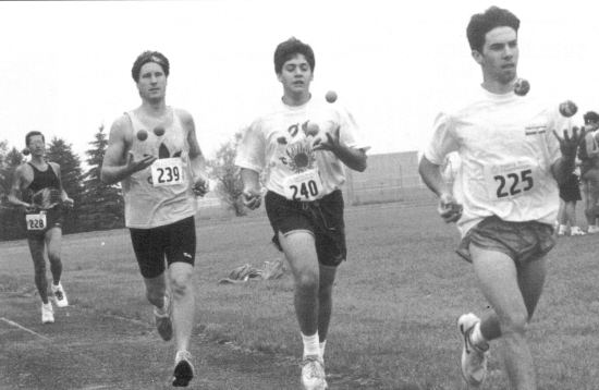 Tony Fitzgerald leads the pack to win the men's mile (Bill Giduz photo)