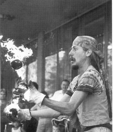 Loon juggles flaming balls.  Capitol Square, Madison, WI