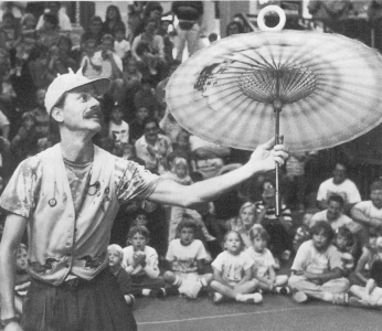 Loon doing a doggie donut on a parasol.  Madison Civic Center, Madison, WI