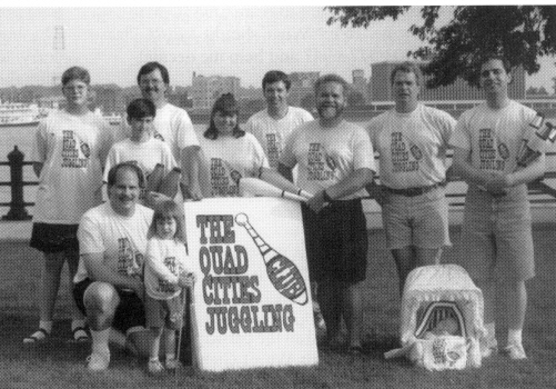 The Quad City Jugglers gathered on the banks of the Mississippi River in Leclaire Park in Davenport, Iowa, to celebrate World Juggling Day.  During the weekend, the performed at a neighborhood festival, juggled in the Genessee Music Festival parade and had a picnic.  Included in the group are (front row, l-r) Larry and Chelsea Neirynck and Beth Dewolf, (standing, l-r) David Holifield, Brian and Randy Huebner, Tiffany Baker, David Heald, Dusty Galbraith, Chuck Field and Doug DeWolf