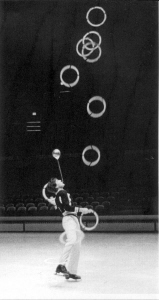 Spinning a hoop on a leg, balancing and flashing nine at age 18.