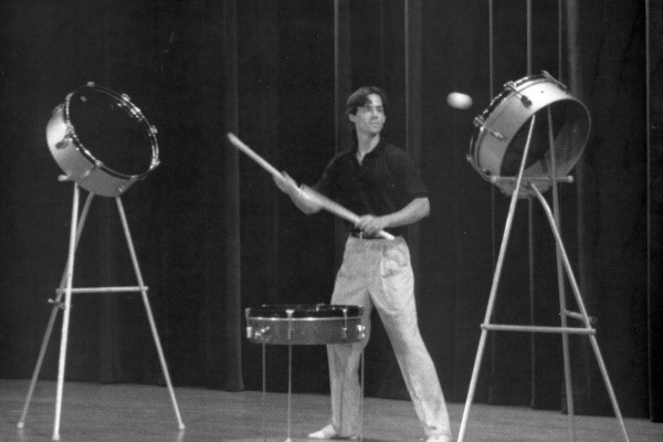 Peter Davison recited a poem about "rebound" in the Cascade of Stars show, accompanying himself creatively with the rhythm of two sticks and a ball bounced and beaten off of a drum on the floor and two more at his sides. (David Carper photo)